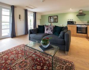 a living room with a couch and a table at Lily pad Lodge in Rous Lench