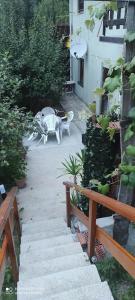 a patio with a table and a table and a chair at Apartman Malina in Fužine +5 photos