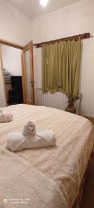 a bedroom with a bed with a towel on it at Apartman Malina in Fužine