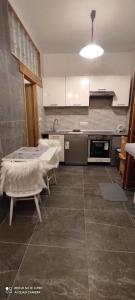 a kitchen with a table and chairs in a room at Apartman Malina in Fužine