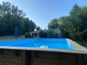 a large blue swimming pool on top of a house at Mas des Maje in Boisredon