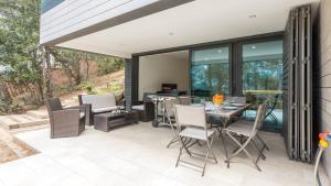 a patio with a table and chairs and windows at VILLA VENEZUELA in Llafranc