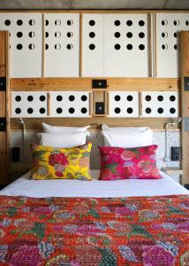 a bedroom with a bed with two pillows and avertisement at JAM Lisbon in Lisbon