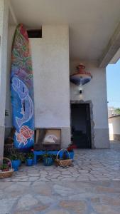 a surfboard on the side of a building at Ianakiev Guest House in Chernomorets