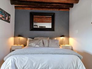 a bedroom with a bed with a mirror on the wall at Sedgefield Lodge in eMalahleni