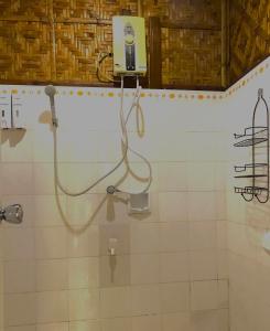 a bathroom with a shower with a camera on the wall at Island Tiki Paradise Resort in Panglao Island