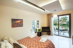 a hotel room with a bed and a balcony at Latchi Escape Hotel and Suites - By IMH Travel & Tours in Neo Chorio