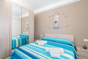una camera da letto con due letti e uno specchio di Apt Giulia a due passi dal mare a Noto Marina