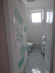 a bathroom with a toilet and a window at Green leaves Challet North Coast k75 in Dawwār Muḩammad Abū Shunaynah