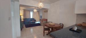 a kitchen and living room with a table and chairs at Spacious 2 bedroom apartment in Peyia