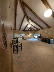 a large room with a bed and a ceiling with beams at La Casa sul Blu Albergo Diffuso in Pisciotta