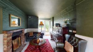a living room with a couch and a fireplace at Hazelhurst Farm in Sway