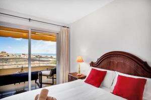 a bedroom with a bed and a view of a balcony at Beautiful Apartament Sol Paraiso BALCONY& SEA POOL in Adeje
