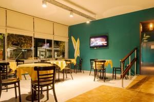 un restaurante con mesas y sillas y una pared verde en Hotel Marciala en Villa Carlos Paz
