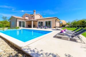 a villa with a swimming pool and a house at Villa Emili by IstriaLux in Svetvinčenat