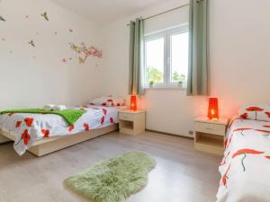 a bedroom with two beds and a window and a rug at Villa Emili by IstriaLux in Svetvinčenat +36 photos