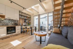 a living room with a couch and a table at Apartamenty Słoneczna Góra w spokojnej okolicy - Dream Apart in Szczyrk