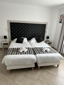 a bedroom with two beds with white sheets and pillows at A STORIA in Bastia