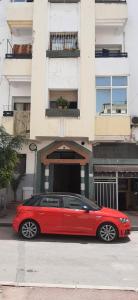 a red car parked in front of a building at Hassan in Rabat