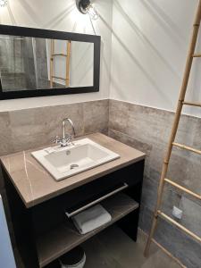 a bathroom with a sink and a ladder at A STORIA in Bastia