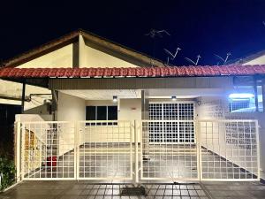a house with a gate in front of it at night at V Lodge in Kuantan