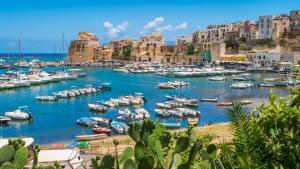 a group of boats in a harbor with buildings at Appartamento sul mare in Castellammare del Golfo
