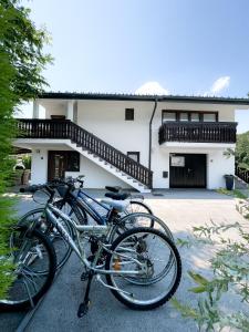 two bikes parked in front of a house at Apartments Sole in Podčetrtek