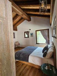 a bedroom with a large bed and a window at Ai Tetti Nuovi in Roccaforte Mondovì