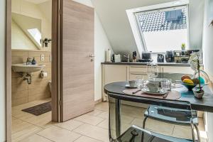 a small kitchen with a table and a sink at Apartment#1 in Kerpen