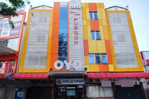 a colorful building with a sign on it at Capital O 142 Hotel Al Furqon Syariah in Palembang