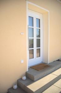 a front door of a house with a window at Landhaus PHILIPP - Ostsee FeWo's in Nienhagen