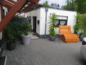 a patio with a bench and some plants at Ferienwohnung Pargen in Bullay