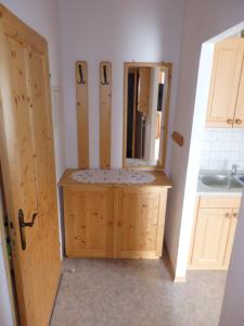 a bathroom with a sink and a counter with a mirror at Apartments Haus Steinbock in Tauplitz