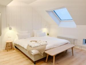 a bedroom with a large bed with a skylight at LaSpa Beach House in Laulasmaa