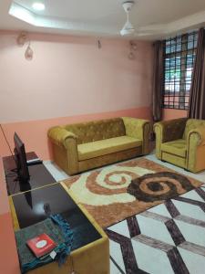 a living room with a couch and a table at Siti Homestay in Pasir Mas