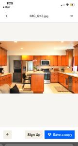 a kitchen with wooden cabinets and a stove top oven at Conveniently located 2bd-LAX-Sofi Stadium-Space X in Inglewood