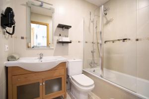 Un baño con lavabo, inodoro y ducha. en Chiclana Bahía D´or Plaza, en Chiclana de la Frontera 18 fotos más