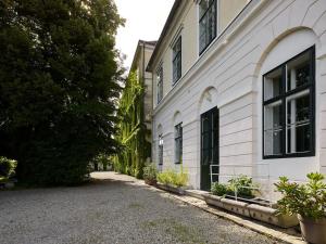 an empty street next to a white building at Schloß Hollenburg Honeymoon Suite in Krems an der Donau