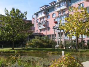 a person standing in front of a pond in front of a building at Evangelische Diakonissenanstalt Stuttgart in Stuttgart