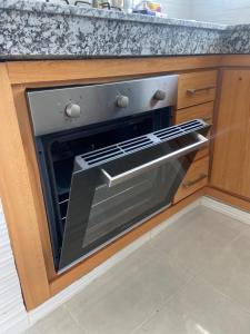 an oven with its door open in a kitchen at Appartement de luxe en bord de mer à Skhirat Plage in Skhirat