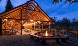a building with a fire pit in front of it at Hotel Krynica Conference & SPA in Krynica Zdrój