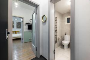 a bathroom with a toilet and a room with a bed at Cute 1bedroom center apartment in Prague