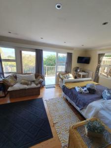 a bedroom with two beds and a balcony at 18 On Thesen. in Knysna