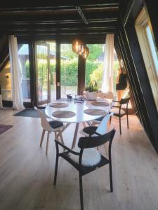 a dining room with a white table and chairs at Ferienhaus Freilingen in Blankenheim