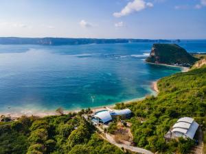 an aerial view of a beach and the ocean at Inlight Lombok Beach Hotel in Kuta Lombok