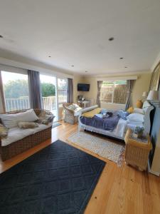 a living room with a bed and a couch at 18 On Thesen. in Knysna