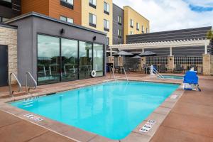 a swimming pool in front of a building at Fairfield Inn & Suites by Marriott Menifee in Menifee