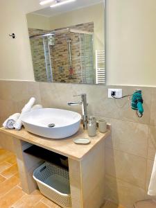 ein Badezimmer mit einem weißen Waschbecken und einem Spiegel in der Unterkunft Il Casaletto in Gavignano