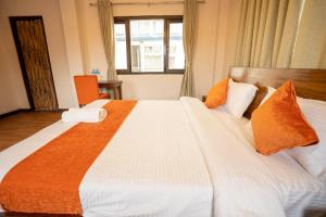 Tempat tidur dalam kamar di Hotel Pala