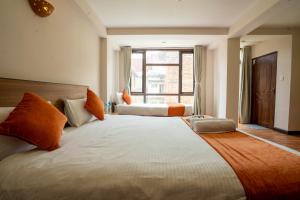 Tempat tidur dalam kamar di Hotel Pala
